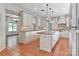 Spacious kitchen featuring terracotta floors, a central island, and abundant white cabinetry at 455 W Gleneagles Rd, Statesville, NC 28625