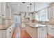 Spacious kitchen with granite countertops, white cabinets, a large island, and stainless steel appliances at 455 W Gleneagles Rd, Statesville, NC 28625
