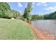 Lakeside property featuring a tranquil lake with a sandy shore and green grassy yard at 455 W Gleneagles Rd, Statesville, NC 28625