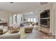 Bright living room featuring a stone fireplace and comfortable seating area with a view to another room at 455 W Gleneagles Rd, Statesville, NC 28625
