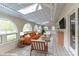 Bright sunroom with tile floor, arched windows, skylight, and comfortable seating arrangement at 455 W Gleneagles Rd, Statesville, NC 28625