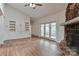 Bright living room showcasing hardwood floors, built-in cabinets, and a stone fireplace at 455 W Gleneagles Rd, Statesville, NC 28625