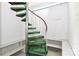 Unique spiral staircase with green carpeted steps and a metal handrail at 455 W Gleneagles Rd, Statesville, NC 28625