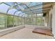 Sunroom with tiled floor and glass ceiling offering beautiful views of the surrounding lake at 455 W Gleneagles Rd, Statesville, NC 28625