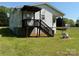 Home's back porch and stairs to basement, with spacious yard at 4787 Rock Barn Rd, Claremont, NC 28610