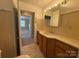 Traditional bathroom with vanity and adjacent bedroom access at 4787 Rock Barn Rd, Claremont, NC 28610