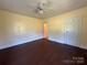 Bedroom with hardwood floors, ceiling fan, and two doors at 4787 Rock Barn Rd, Claremont, NC 28610