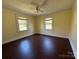 Bright bedroom featuring hardwood floors and two windows at 4787 Rock Barn Rd, Claremont, NC 28610