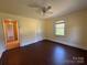 Bedroom with hardwood floors, ceiling fan, and window at 4787 Rock Barn Rd, Claremont, NC 28610