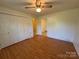 Bright bedroom with hardwood floors, closet and door to an adjacent room at 4787 Rock Barn Rd, Claremont, NC 28610