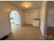 Dining area with tile flooring with an arched entry to the kitchen at 4787 Rock Barn Rd, Claremont, NC 28610