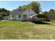 Quaint home featuring a front porch, wheelchair ramp, and a carport at 4787 Rock Barn Rd, Claremont, NC 28610