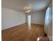 A bright living room features wood floors, white walls, and a ceiling fan at 4787 Rock Barn Rd, Claremont, NC 28610