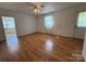 Bright living room with hardwood floors, ceiling fan, and natural light at 4787 Rock Barn Rd, Claremont, NC 28610