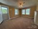 Bright living room with natural light, neutral carpet, and view of lush exterior at 4787 Rock Barn Rd, Claremont, NC 28610