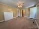 Cozy living room featuring a white brick fireplace and neutral carpeting at 4787 Rock Barn Rd, Claremont, NC 28610