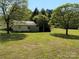View of the shed with partial cover, surrounded by a large yard at 4787 Rock Barn Rd, Claremont, NC 28610