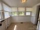 Sunroom with tile flooring, and multiple windows with backyard views at 4787 Rock Barn Rd, Claremont, NC 28610