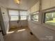 Bright sunroom with a tile floor and multiple windows with a garden view at 4787 Rock Barn Rd, Claremont, NC 28610