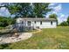 A beautiful backyard featuring a firepit and large open yard with a deck attached at 504 N Hawthorne St, Mount Holly, NC 28120