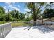 A bright outdoor deck for relaxation with a gorgeous green and blue summer skyline at 504 N Hawthorne St, Mount Holly, NC 28120