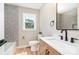 This renovated bathroom has modern fixtures, stylish tile, and a herringbone-patterned floor at 504 N Hawthorne St, Mount Holly, NC 28120