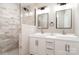 Bathroom with a double vanity, vessel sinks, framed mirrors, tiled walls and a shower at 504 N Hawthorne St, Mount Holly, NC 28120
