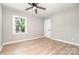 Bright bedroom with hardwood floors, neutral paint, a window, and ceiling fan at 504 N Hawthorne St, Mount Holly, NC 28120