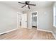 A bright bedroom features hardwood floors and a ceiling fan with bathroom views at 504 N Hawthorne St, Mount Holly, NC 28120