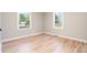 The airy bedroom is illuminated with natural light with gleaming hardwood floors at 504 N Hawthorne St, Mount Holly, NC 28120