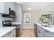 Kitchen complete with stainless appliances, quartz counters, subway tile backsplash, and updated cabinetry at 504 N Hawthorne St, Mount Holly, NC 28120