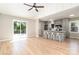 Open-concept kitchen and living area, complete with stainless appliances, quartz counters, and outdoor deck access at 504 N Hawthorne St, Mount Holly, NC 28120