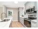 Kitchen complete with stainless appliances, quartz counters, subway tile backsplash, and updated cabinetry at 504 N Hawthorne St, Mount Holly, NC 28120