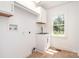 Bright laundry room with utility sink, window, and cabinetry at 504 N Hawthorne St, Mount Holly, NC 28120