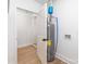 An open basement shows the hot water heater, brick wall, and access to additional rooms at 5514 Milford Rd, Charlotte, NC 28210