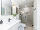 This modern bathroom boasts sleek fixtures, a glass enclosed shower, and neutral color palette at 5514 Milford Rd, Charlotte, NC 28210