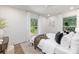 Sunlit bedroom boasts hardwood floors, neutral decor, and large windows providing ample natural light at 5514 Milford Rd, Charlotte, NC 28210