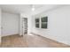 A bright bedroom with hardwood floors, a ceiling fan, and a double window for natural light at 5514 Milford Rd, Charlotte, NC 28210