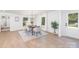Light-filled dining room with modern chandelier, seating for six, and view of the front lawn at 5514 Milford Rd, Charlotte, NC 28210