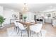 Modern dining room featuring stylish light fixture, seating for six, and open view into the kitchen at 5514 Milford Rd, Charlotte, NC 28210