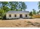 Attractive single-story home features a well-maintained lawn, gray accents, a cozy front porch and welcoming entrance at 5514 Milford Rd, Charlotte, NC 28210