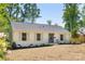 Charming, renovated single-story home with painted brick, manicured landscaping, and a welcoming front entrance at 5514 Milford Rd, Charlotte, NC 28210