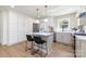 Well-lit kitchen with a modern island, barstool seating, and state-of-the-art stainless steel appliances at 5514 Milford Rd, Charlotte, NC 28210