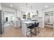 Bright, open kitchen features a modern island, barstool seating, and stainless steel appliances at 5514 Milford Rd, Charlotte, NC 28210