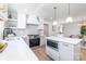 Bright kitchen boasts stainless steel appliances, island with microwave, and a view to the dining area at 5514 Milford Rd, Charlotte, NC 28210