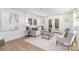 Cozy living room is bright, with a glass coffee table, neutral toned furniture, and outdoor access at 5514 Milford Rd, Charlotte, NC 28210
