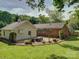 Brick patio with furniture, backyard, and an aerial view of home at 5601 Londonderry Rd, Charlotte, NC 28210