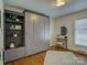 Bedroom with hardwood floors, modern closet, and built-in shelves at 5601 Londonderry Rd, Charlotte, NC 28210