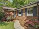The exterior of a brick home featuring well manicured landscaping and a walkway at 5601 Londonderry Rd, Charlotte, NC 28210