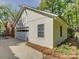 A bright white garage with an automatic door and small windows for lots of natural light at 5601 Londonderry Rd, Charlotte, NC 28210